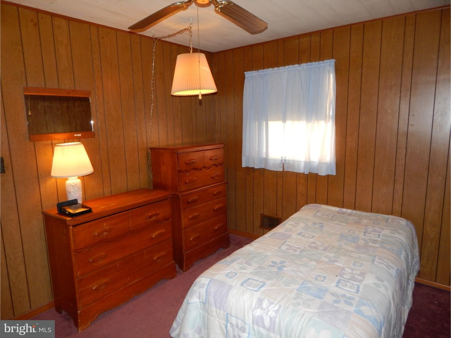 25 Downing Road Hamilton, NJ 08690 - Photo 9 of 14 a bedroom with a bed and a chandelier