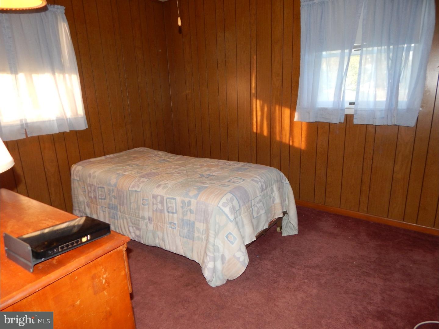 25 Downing Road Hamilton, NJ 08690 - Photo 10 of 14 a bed sitting in a bedroom next to a window
