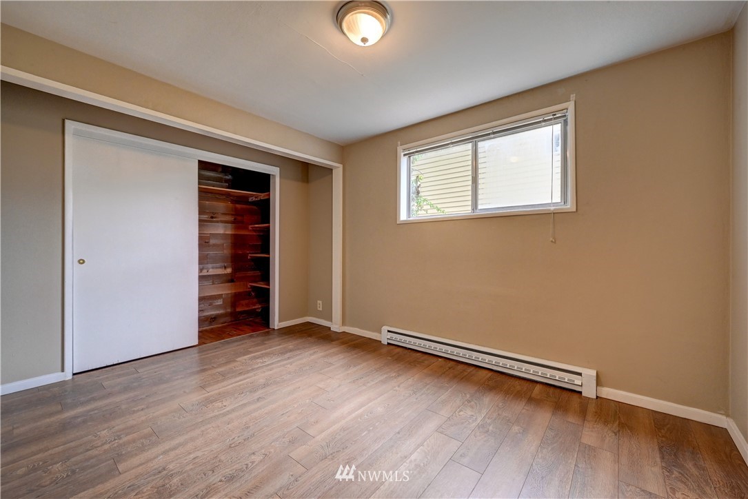 3232 Southeast 5th Street Renton, WA 98058 - Photo 14 of 20 an empty room with wooden floor and windows