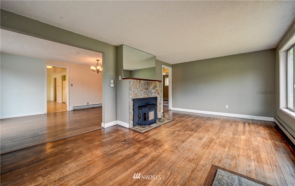 3232 Southeast 5th Street Renton, WA 98058 - Photo 3 of 20 a view of empty room with wooden floor and fireplace
