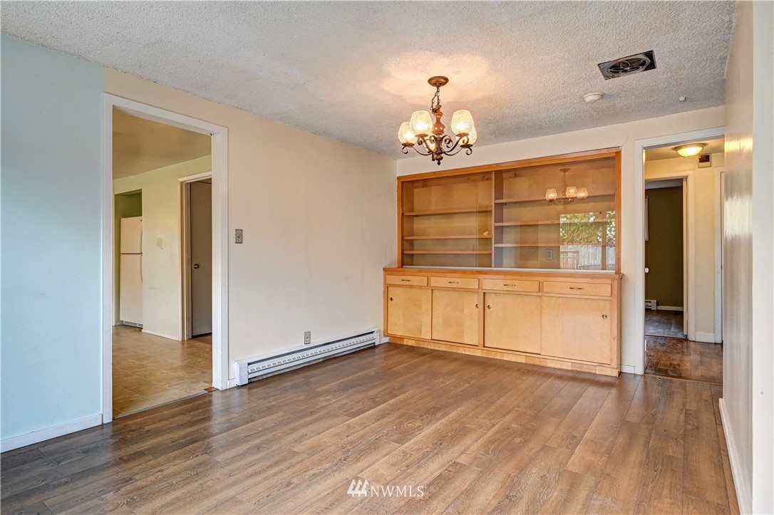 3232 Southeast 5th Street Renton, WA 98058 - Photo 5 of 20 wooden floor in an empty room with a window