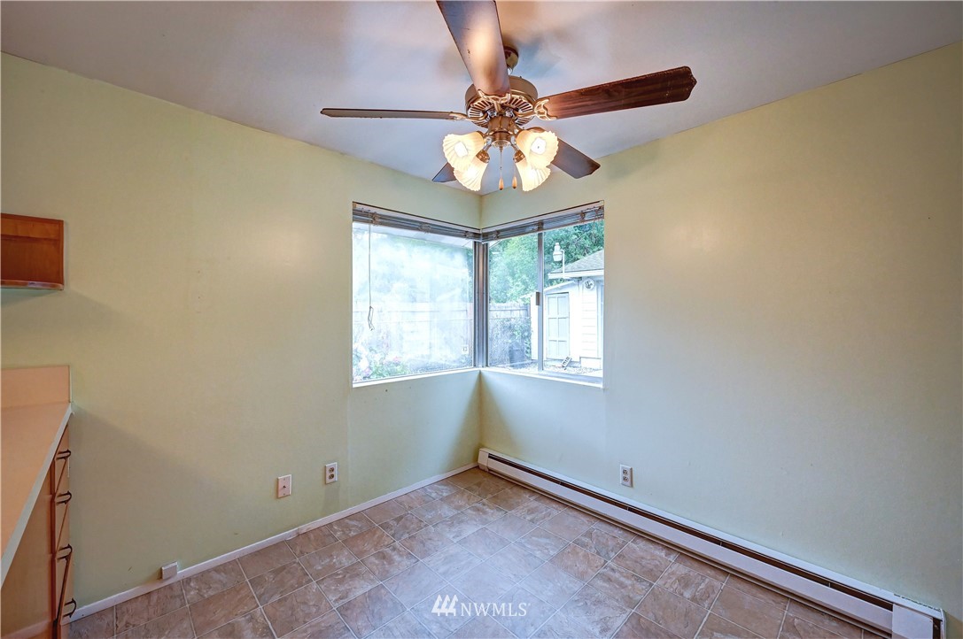 3232 Southeast 5th Street Renton, WA 98058 - Photo 8 of 20 an empty room with windows and chandelier fan