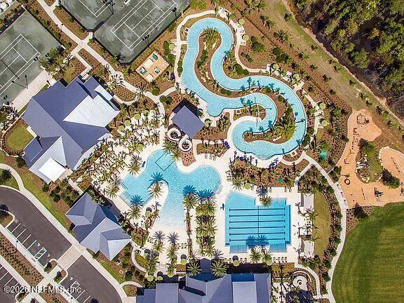 an aerial view of a residential building with an outdoor space