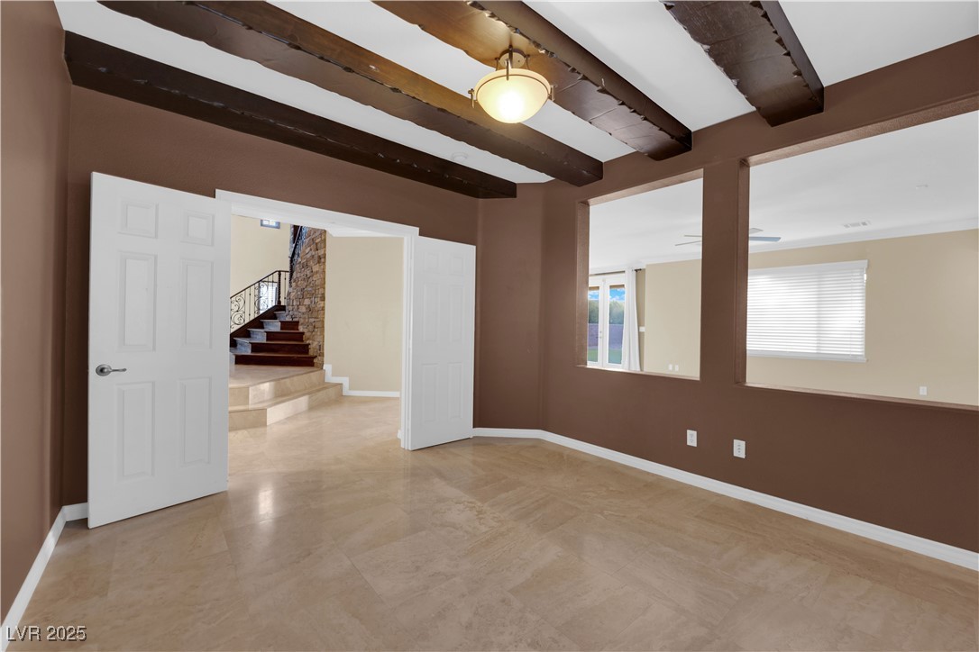 10057 Portula Valley Street Las Vegas, NV 89178 - Photo 24 of 56 Unfurnished room with beamed ceiling and stairway