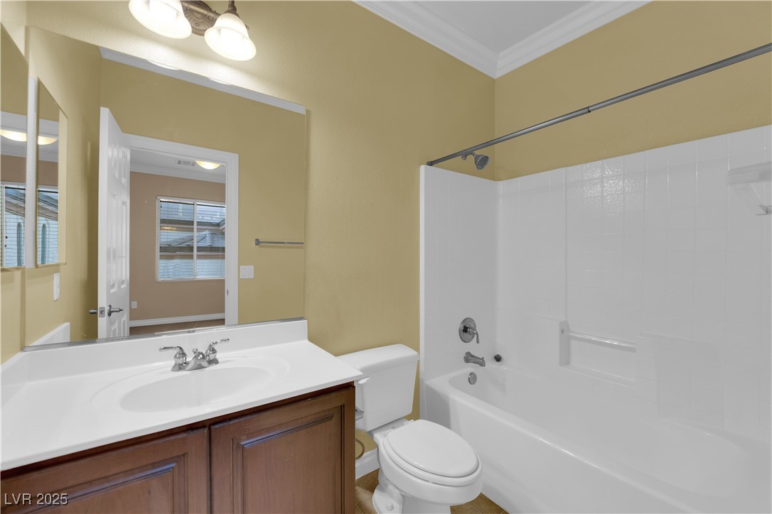 10057 Portula Valley Street Las Vegas, NV 89178 - Photo 40 of 56 Full bath with crown molding, bathing tub / shower combination, and vanity