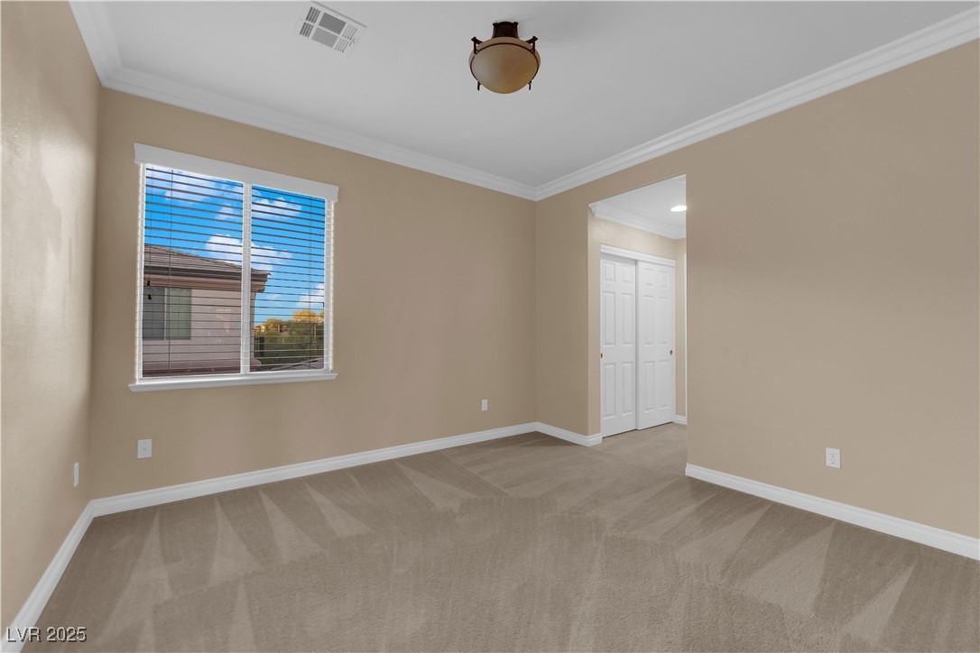 10057 Portula Valley Street Las Vegas, NV 89178 - Photo 41 of 56 Spare room featuring crown molding and light colored carpet