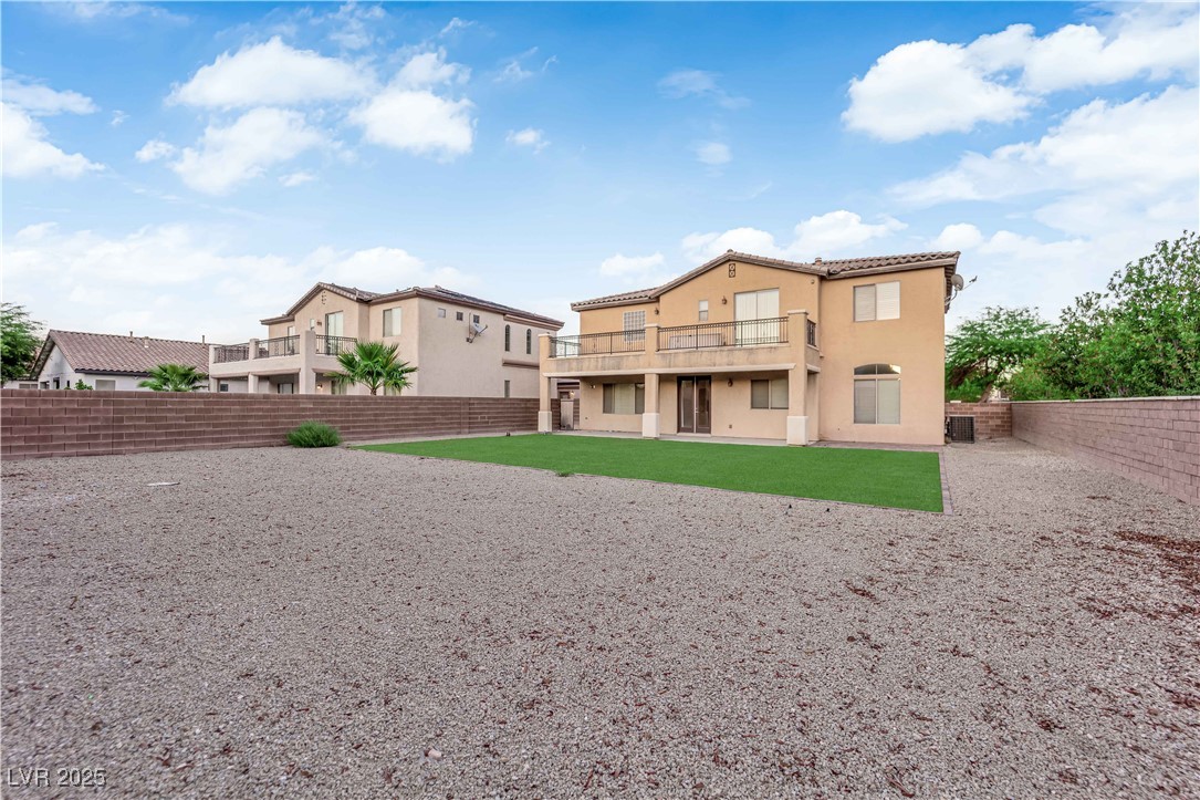 10057 Portula Valley Street Las Vegas, NV 89178 - Photo 50 of 56 Rear view of house featuring stucco siding, a fenced backyard, a patio area, and a tile roof