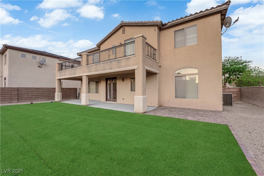 10057 Portula Valley Street Las Vegas, NV 89178 - Photo 52 of 56 Rear view of property featuring a patio, stucco siding, a tiled roof, a fenced backyard, and a balcony
