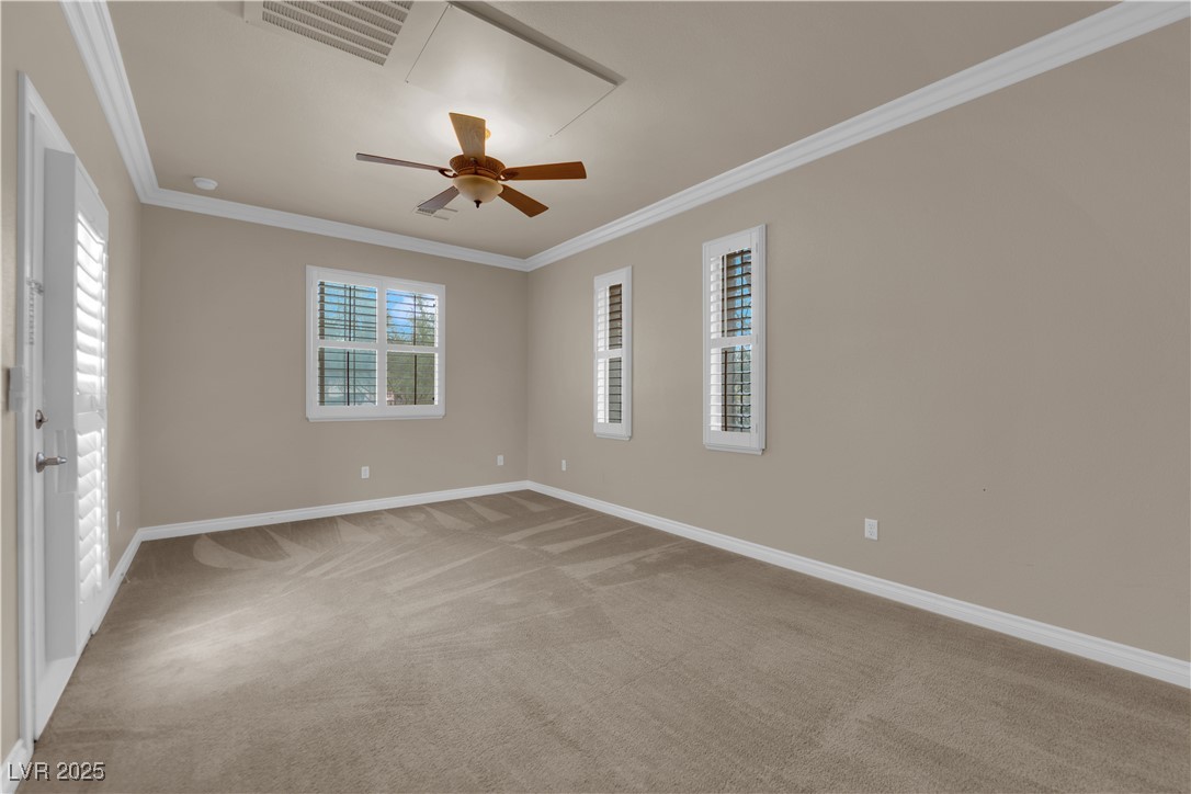 10057 Portula Valley Street Las Vegas, NV 89178 - Photo 54 of 56 Empty room featuring crown molding, light carpet, and ceiling fan