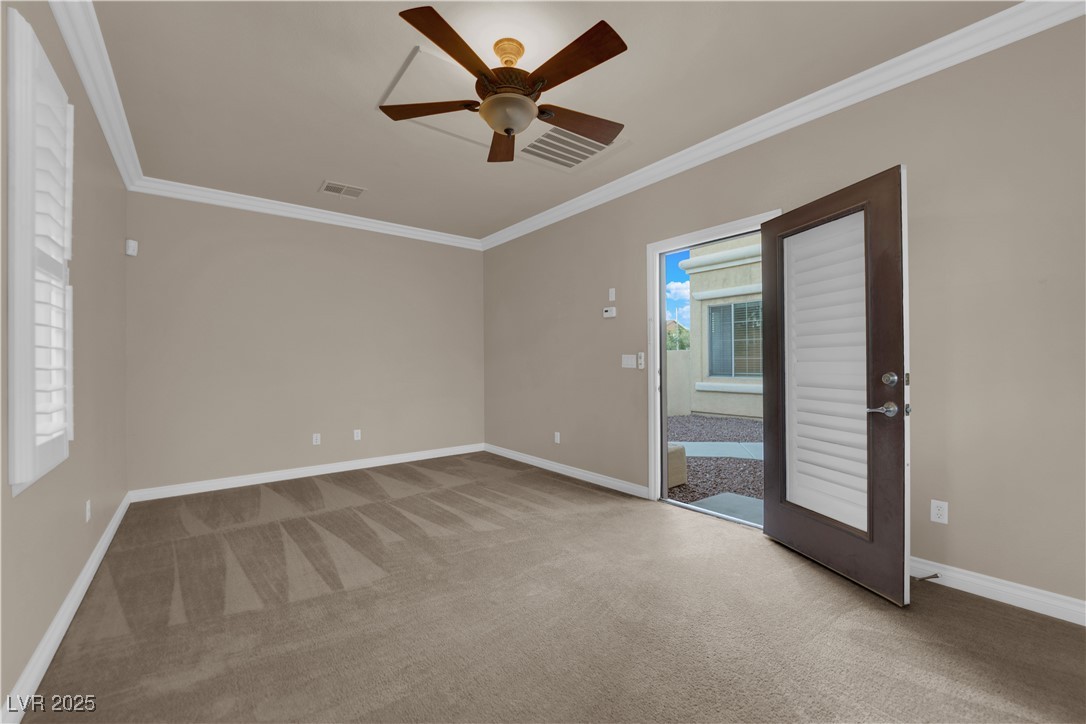 10057 Portula Valley Street Las Vegas, NV 89178 - Photo 55 of 56 Spare room with crown molding, light carpet, and a ceiling fan