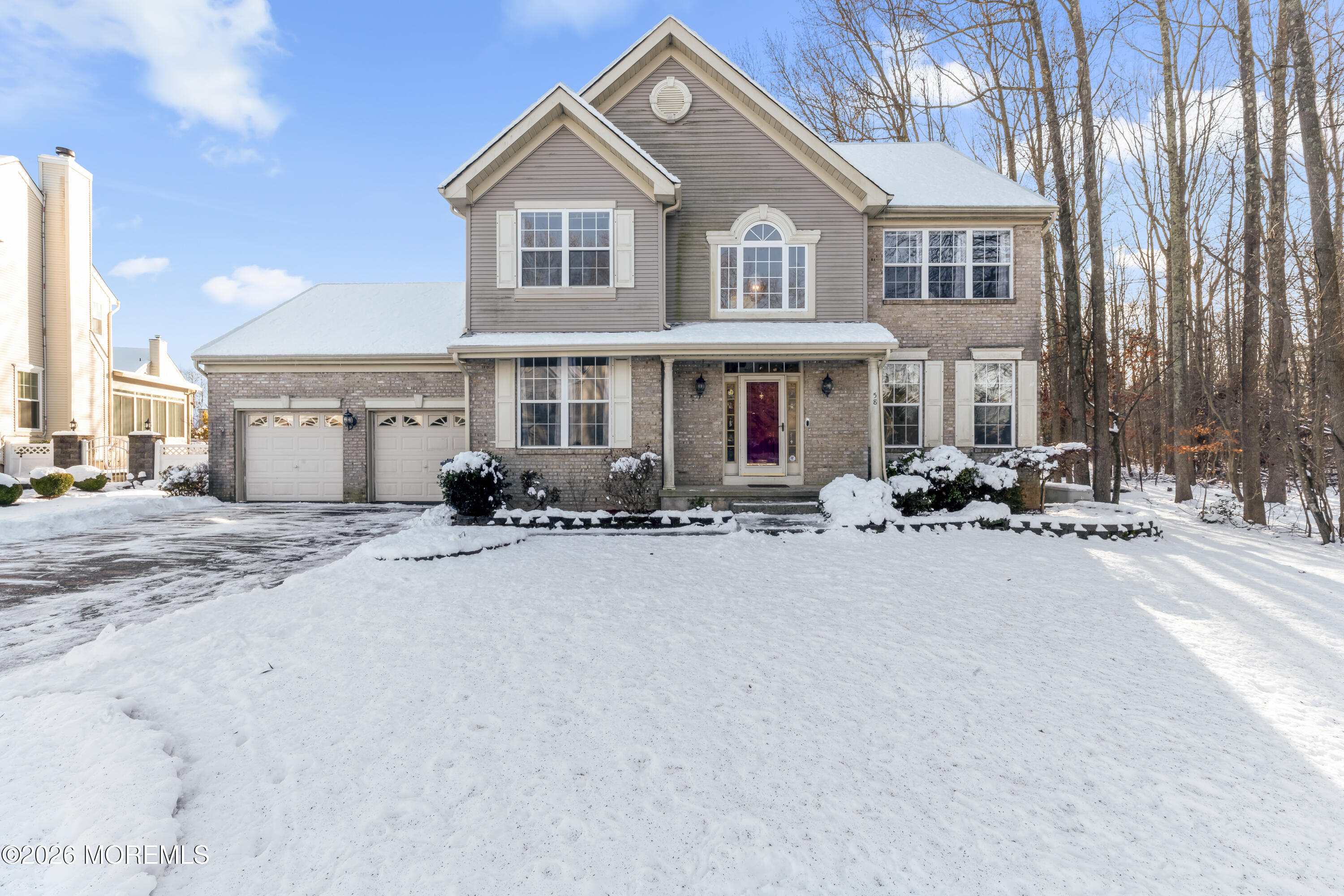 a front view of a house with cars parked
