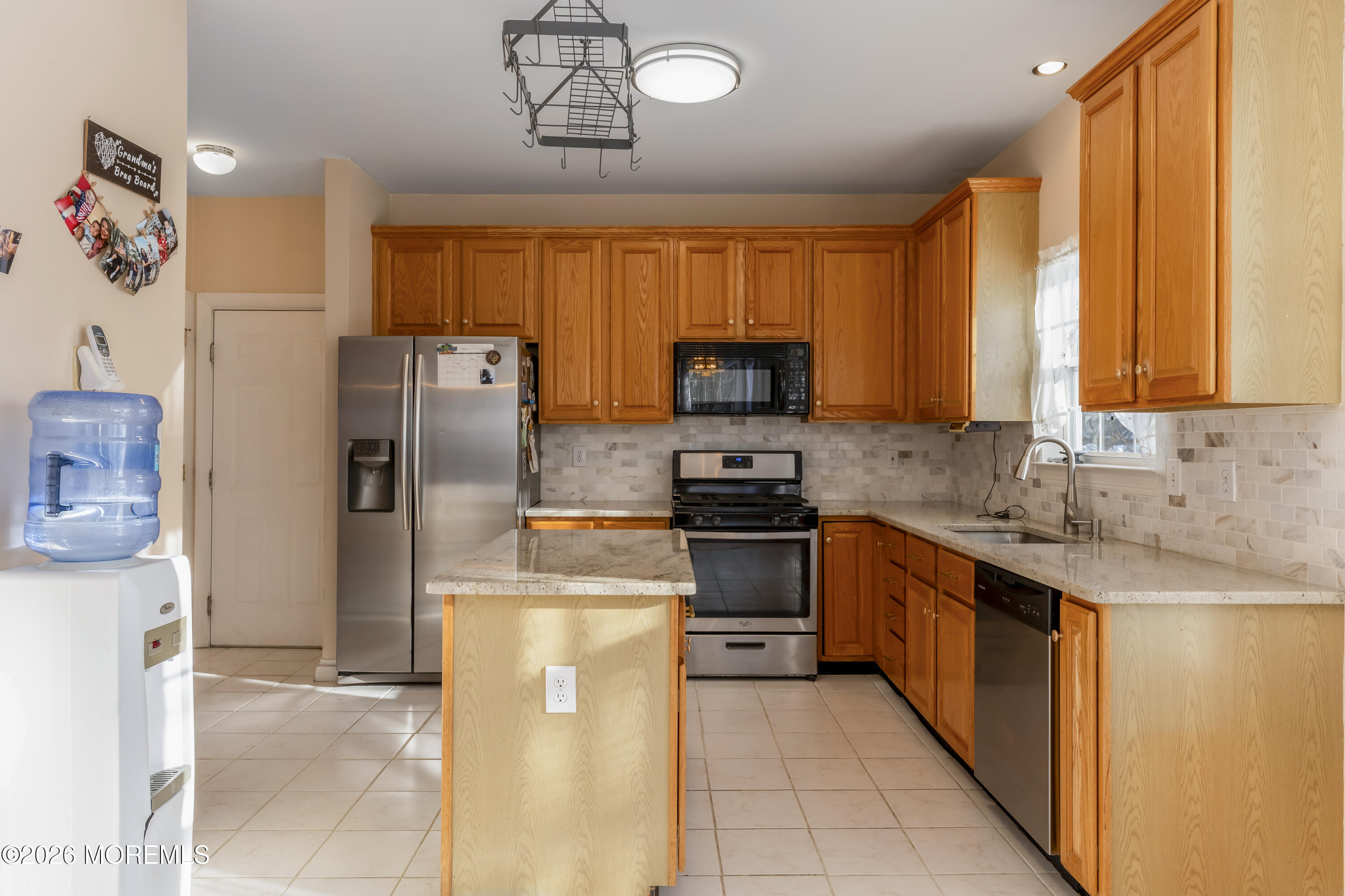 58 Danella Way Howell, NJ 07731 - Photo 12 of 46 a kitchen with stainless steel appliances granite countertop a refrigerator a stove top oven a sink and dishwasher