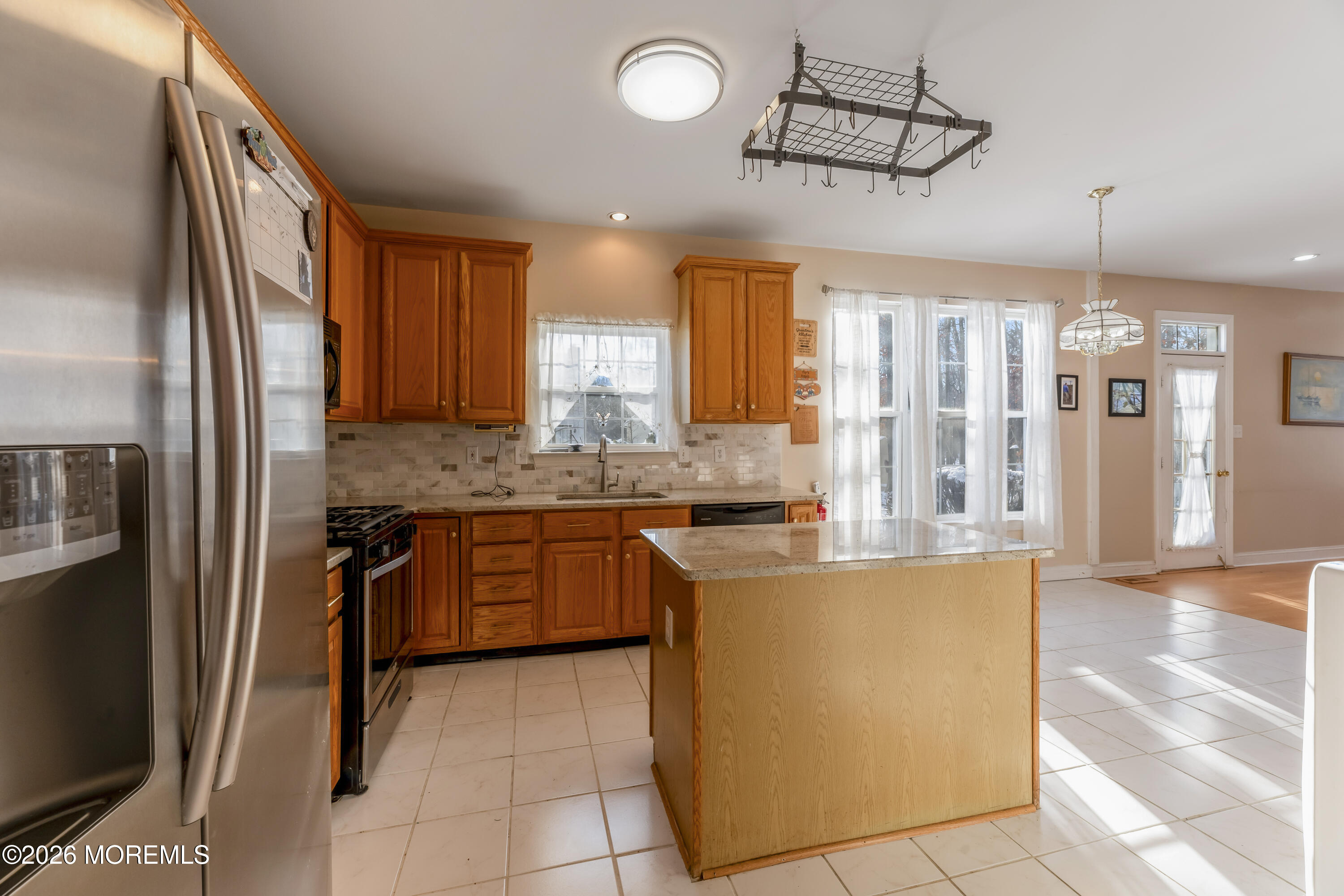 58 Danella Way Howell, NJ 07731 - Photo 14 of 46 a kitchen with stainless steel appliances granite countertop a refrigerator a sink and a stove