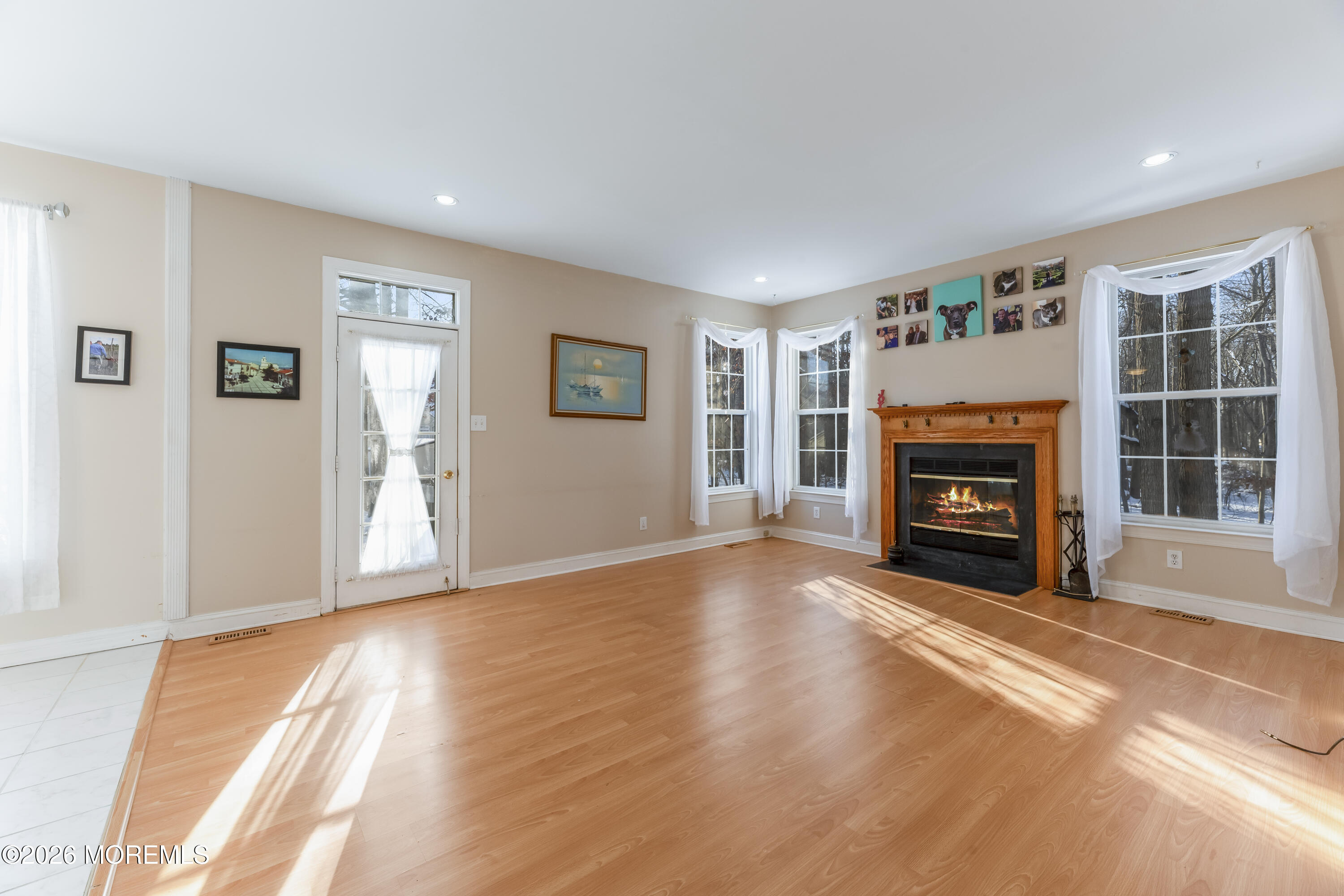 58 Danella Way Howell, NJ 07731 - Photo 16 of 46 a view of empty room with windows and fireplace