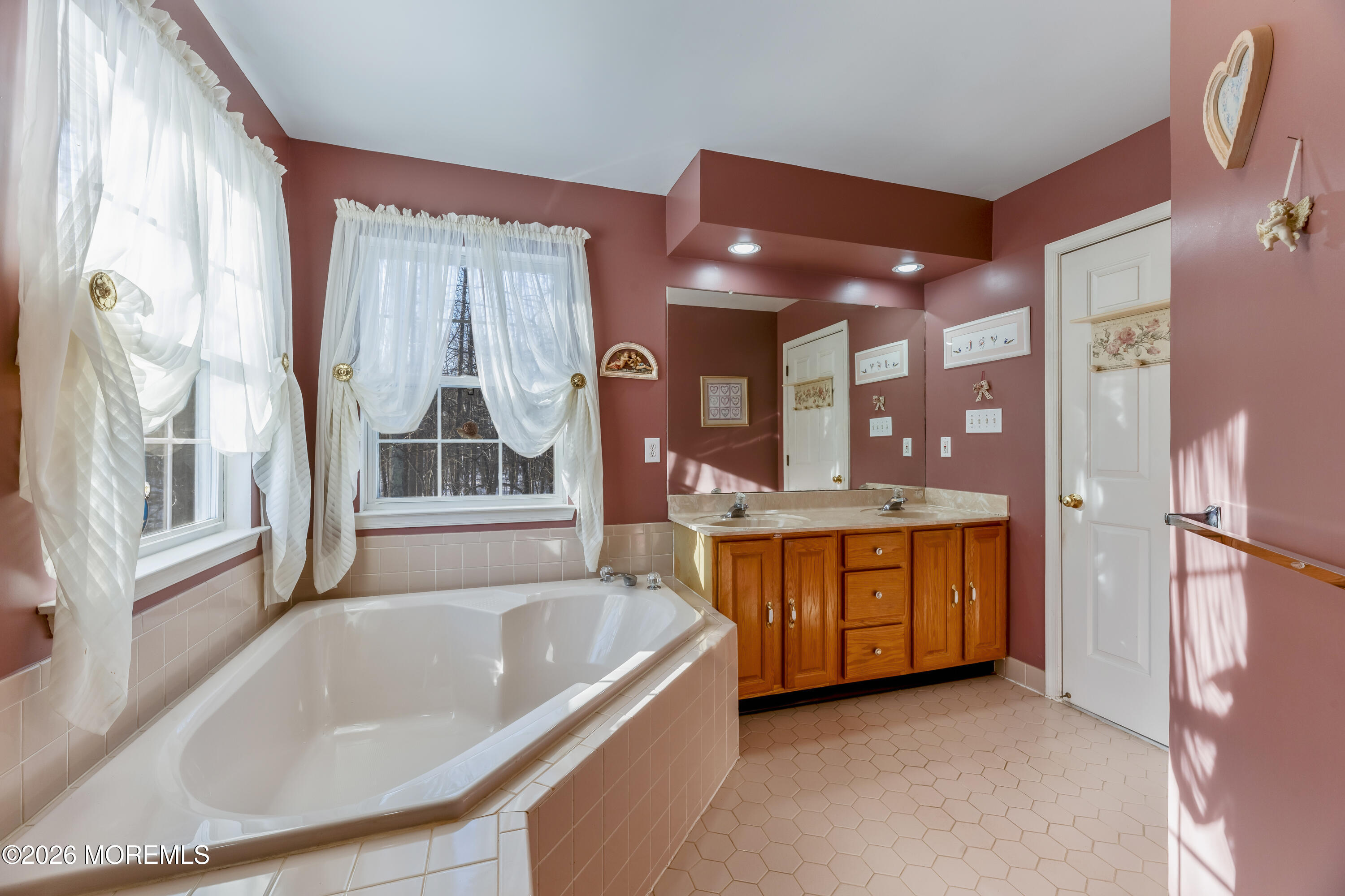 58 Danella Way Howell, NJ 07731 - Photo 23 of 46 a bathroom with a tub a sink and a large window