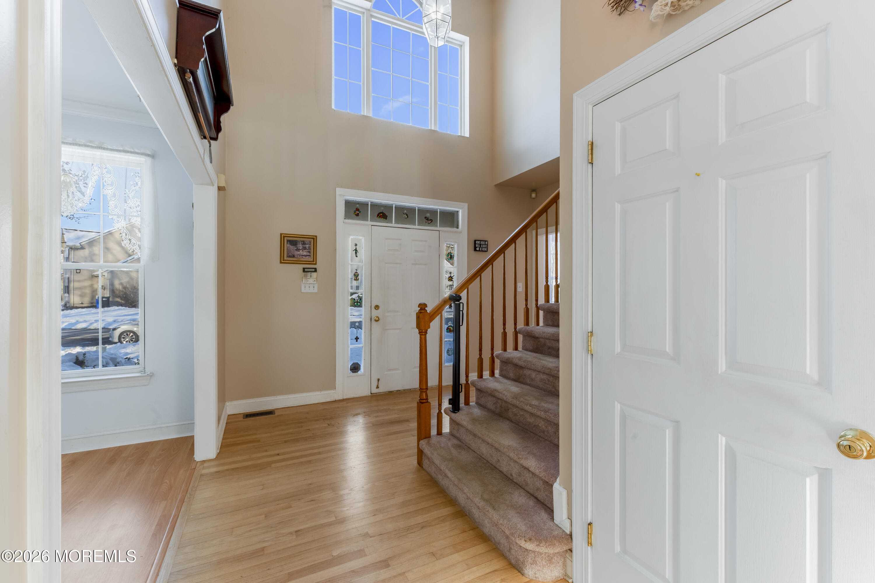 58 Danella Way Howell, NJ 07731 - Photo 5 of 46 a view of a hallway with wooden floor and staircase