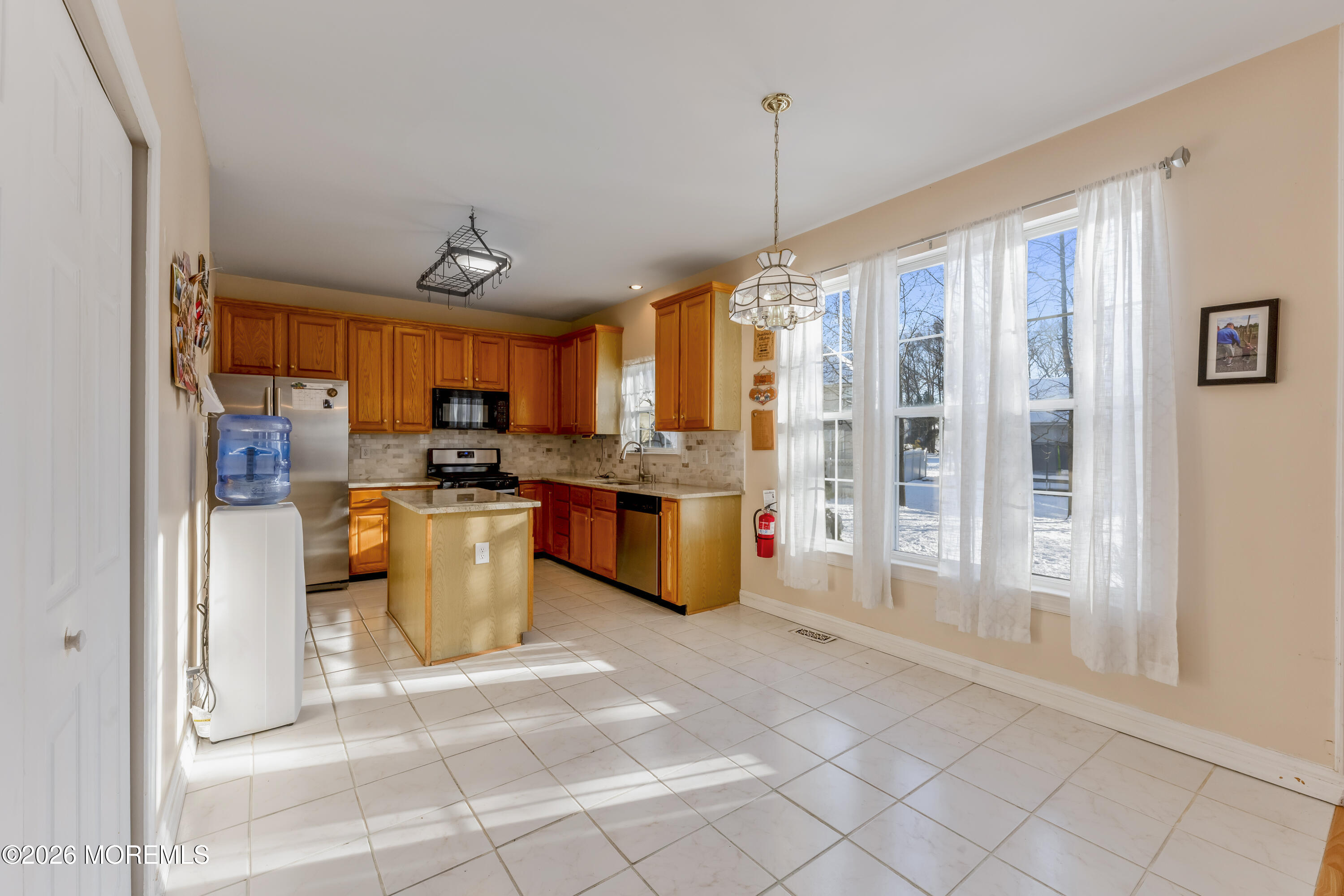 58 Danella Way Howell, NJ 07731 - Photo 10 of 46 a kitchen with stainless steel appliances granite countertop a refrigerator and a sink