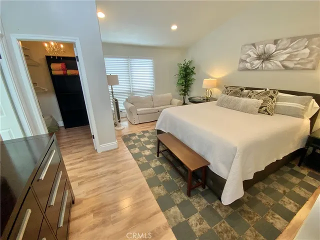 a bed sitting in a bedroom next to a window