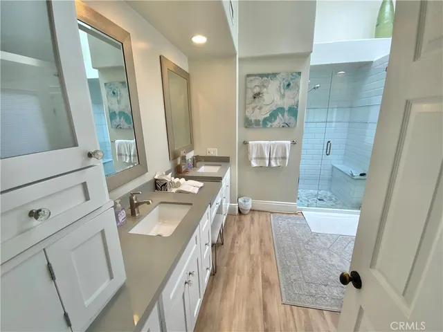 a bathroom with a sink a tub and a mirror