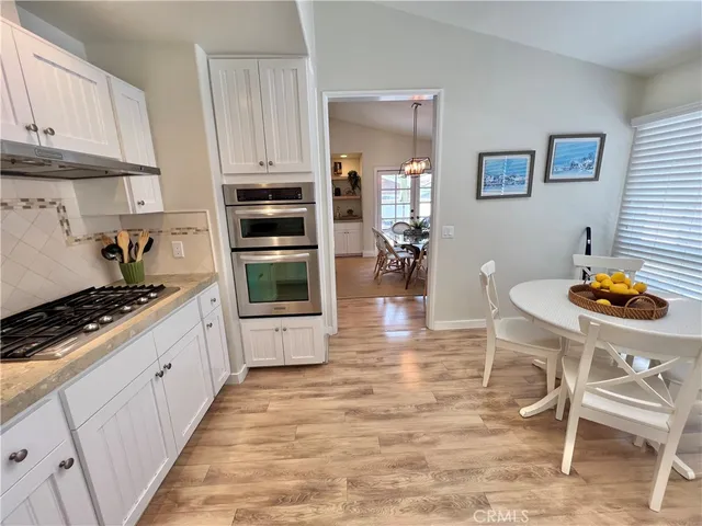 a kitchen with stainless steel appliances granite countertop a stove and a refrigerator
