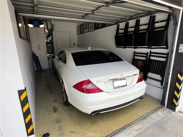a bedroom with a bed and teddy bear on the wall