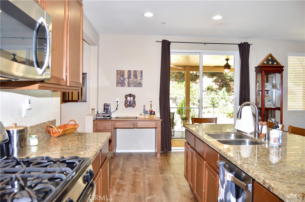 166 Fox Lane Calimesa, CA 92320 - Photo 24 of 76 This Kitchen is a Great Place to Gather with Granite-topped Counters, Island Seating, Stainless Steel Appliances, a Coffee Bar, and a Walk-in Pantry - All Open to the Living Area, Dining Room, and Back Patio