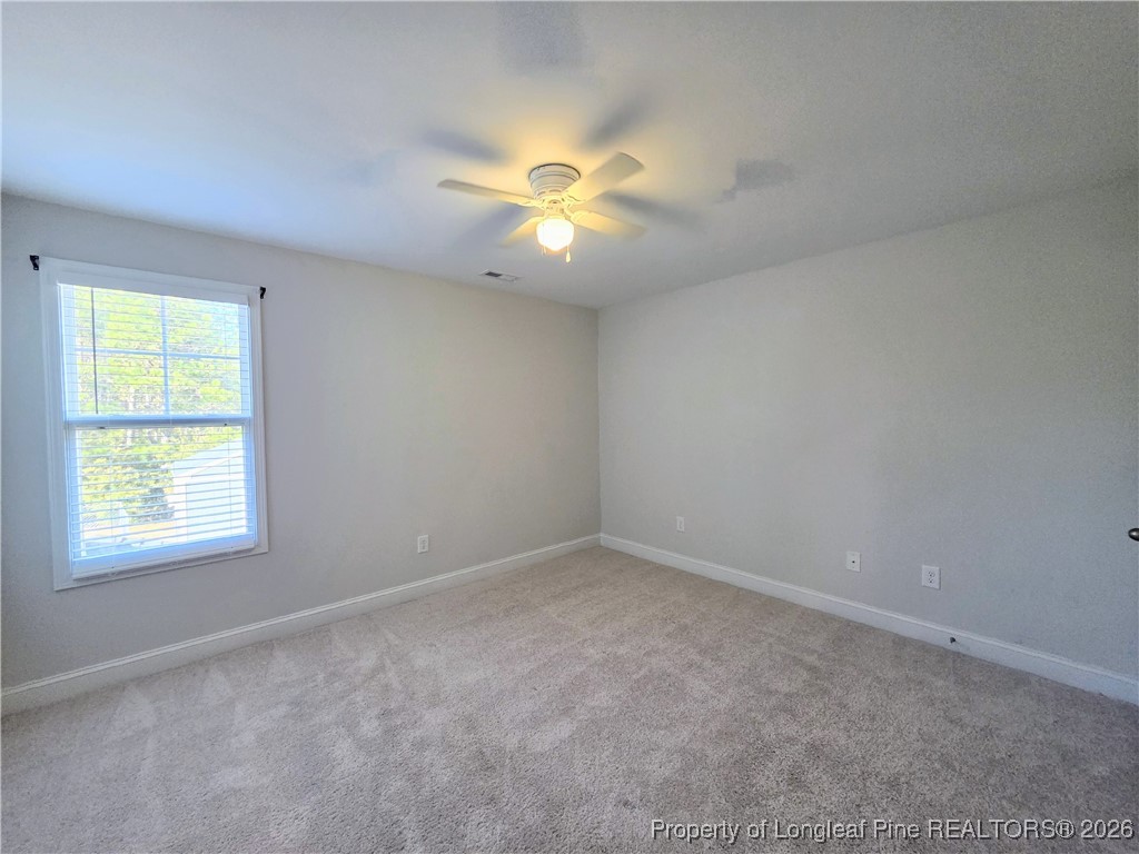 7850 Rufus Johnson Road Fayetteville, NC 28306 - Photo 17 of 25 an empty room with a window and a fan