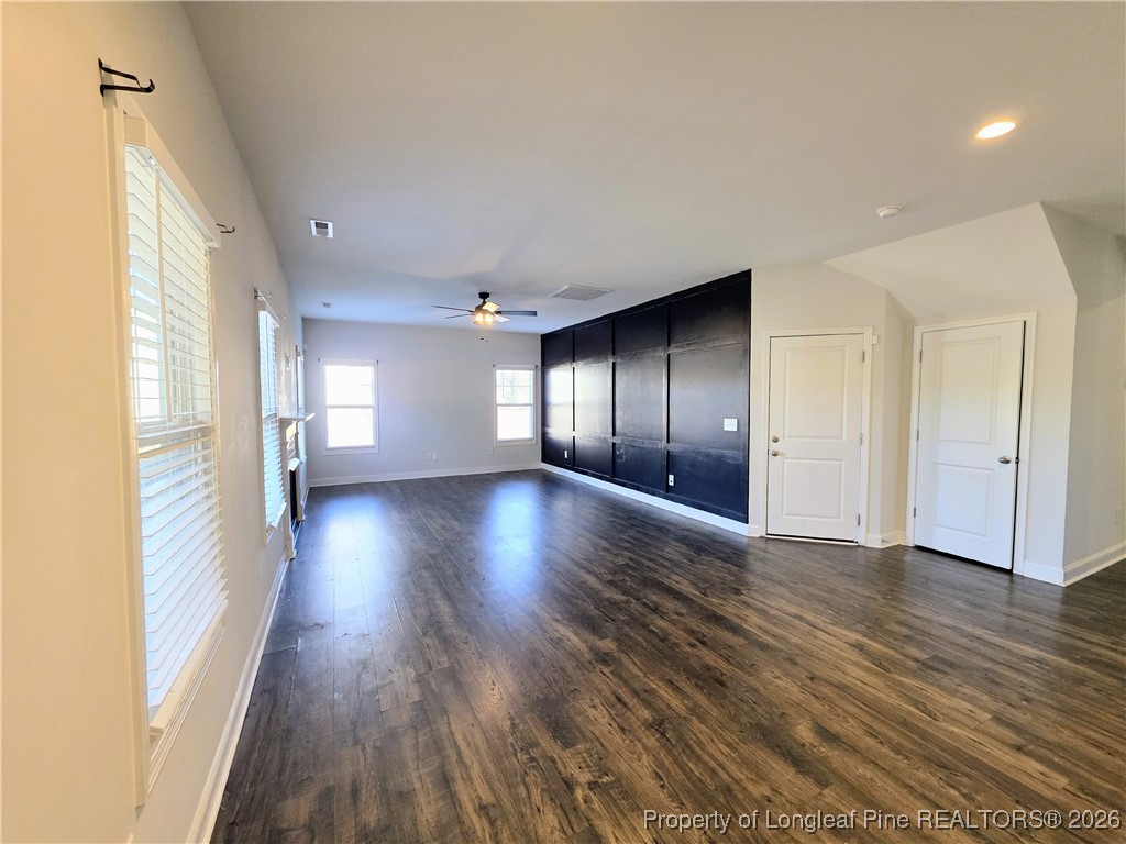 7850 Rufus Johnson Road Fayetteville, NC 28306 - Photo 3 of 25 a view of an empty room with wooden floor and a window