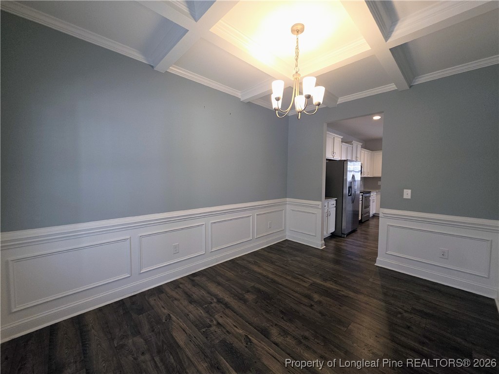 7850 Rufus Johnson Road Fayetteville, NC 28306 - Photo 8 of 25 a view of an empty room with wooden floor and a kitchen