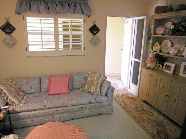 1051 3rd Street South, Unit 301 Naples, FL 34102 - Photo 13 of 15 a living room with furniture and a window