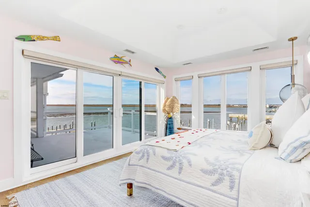 a bedroom with a bed and a large window