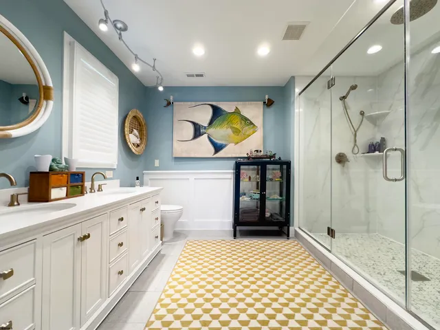 a bathroom with a sink a toilet and shower