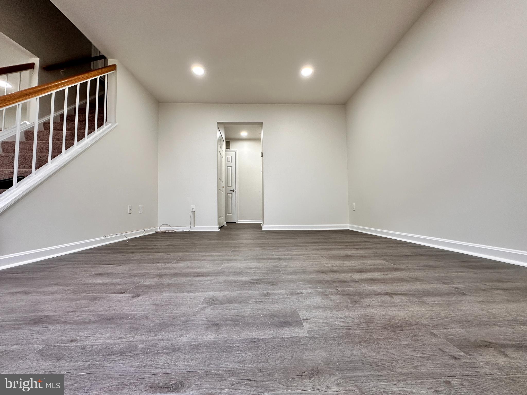31 Amarillo Court, Unit 113 Germantown, MD 20874 - Photo 14 of 24 a view of an empty room with wooden floor