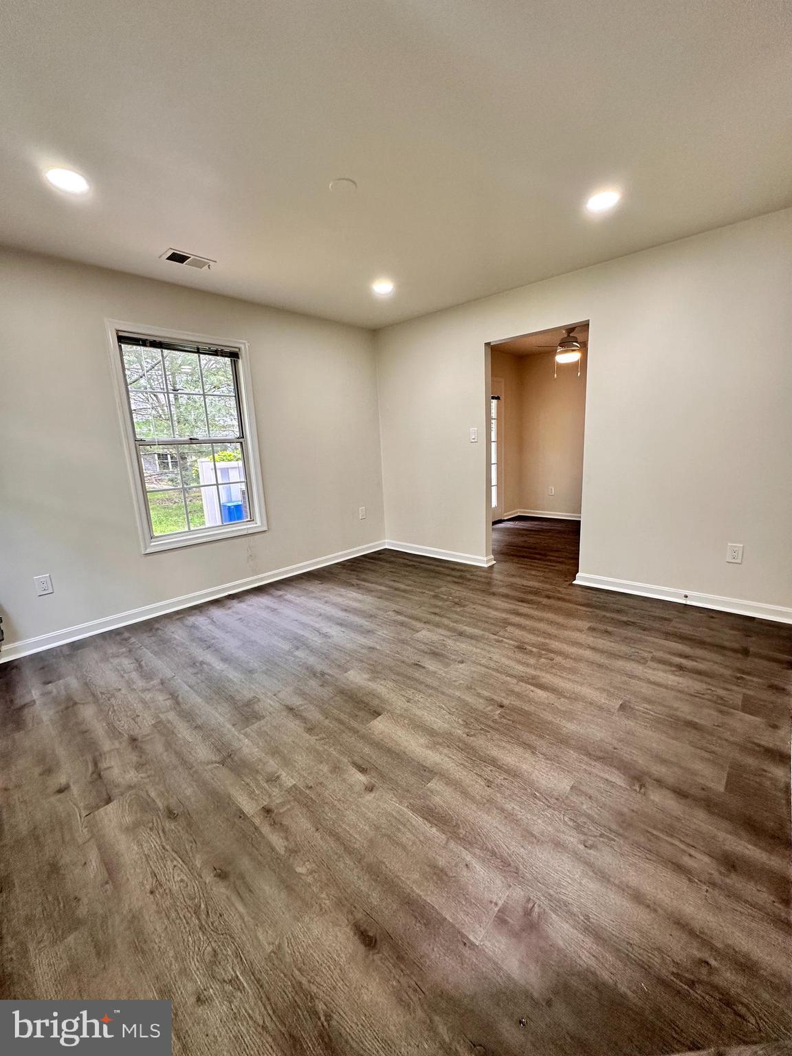 31 Amarillo Court, Unit 113 Germantown, MD 20874 - Photo 21 of 24 an empty room with wooden floor and windows