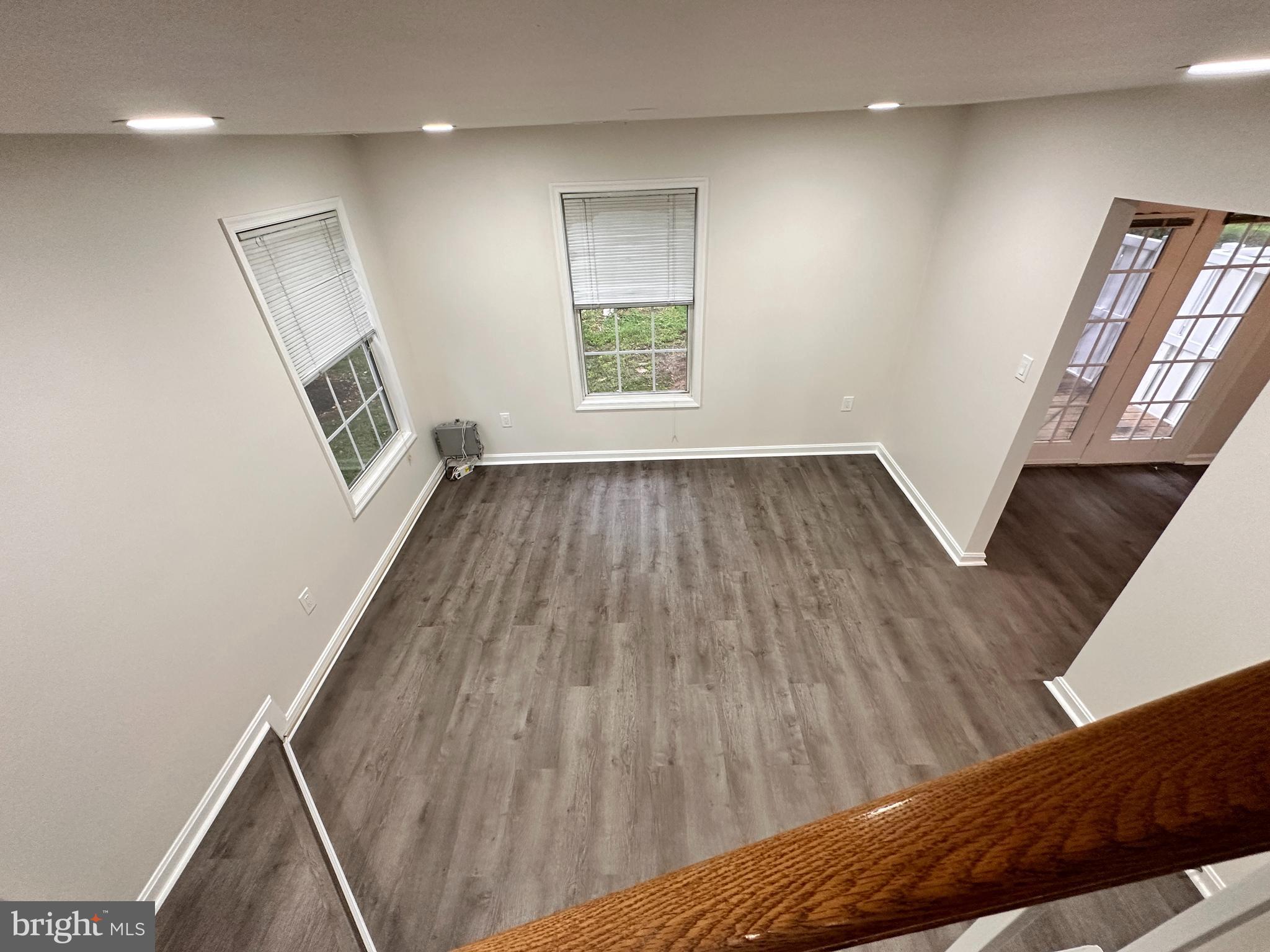 31 Amarillo Court, Unit 113 Germantown, MD 20874 - Photo 24 of 24 a view of an empty room with wooden floor and a window