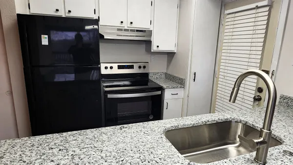 a kitchen with a stove and a refrigerator