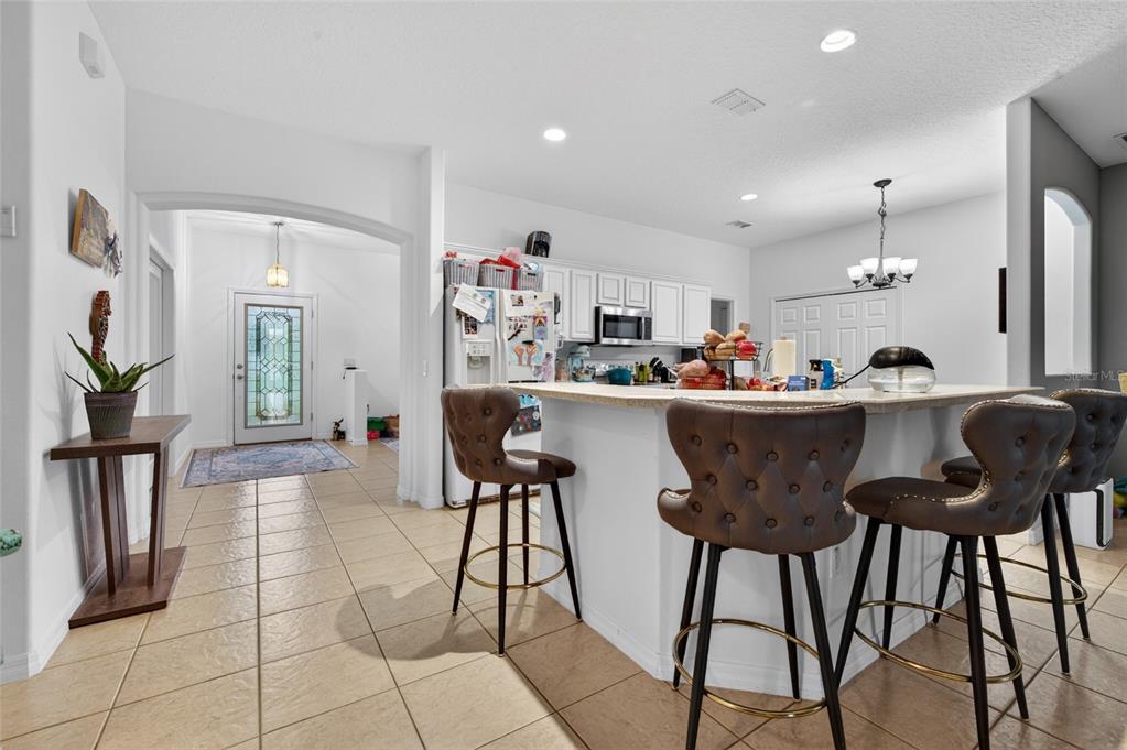 339 Mariners Gate Drive Edgewater, FL 32141 - Photo 13 of 41 a kitchen with a dining table chairs and refrigerator