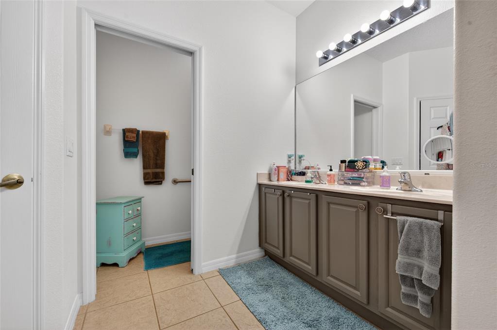 339 Mariners Gate Drive Edgewater, FL 32141 - Photo 20 of 41 a bathroom with a sink a toilet and mirror