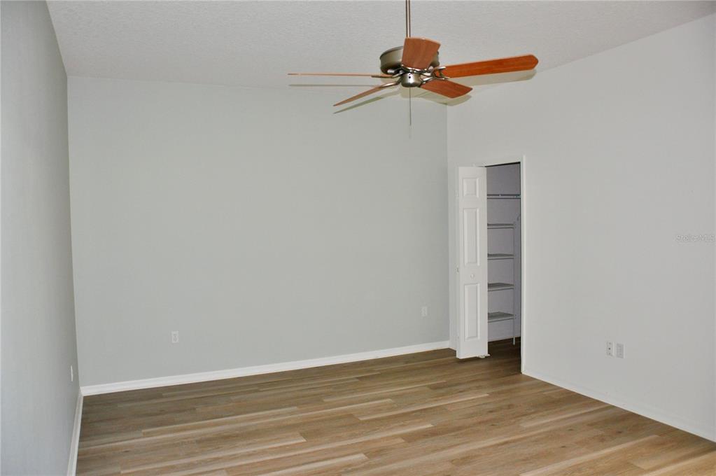 339 Mariners Gate Drive Edgewater, FL 32141 - Photo 22 of 41 a view of a room with wooden floor and fan