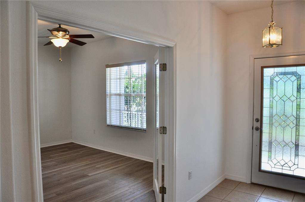 339 Mariners Gate Drive Edgewater, FL 32141 - Photo 24 of 41 a view of an empty room with wooden floor and a window