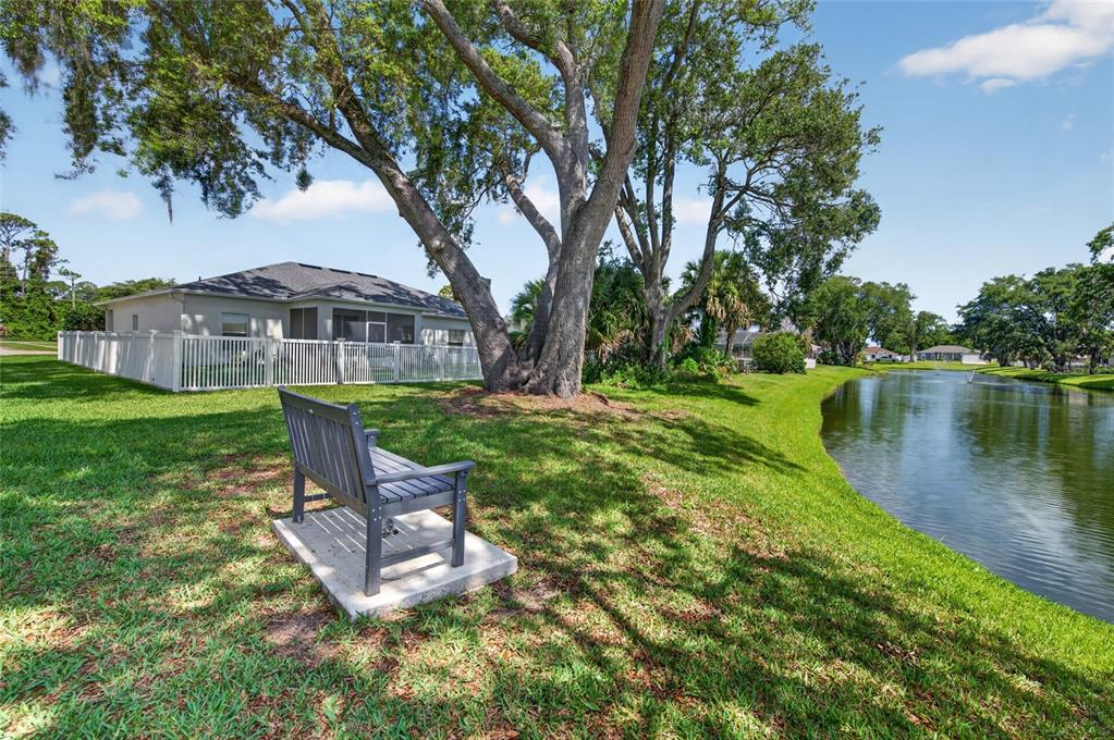 339 Mariners Gate Drive Edgewater, FL 32141 - Photo 4 of 41 a view of a lake with a garden and trees