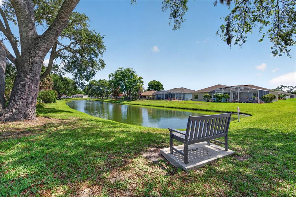 339 Mariners Gate Drive Edgewater, FL 32141 - Photo 5 of 41 a view of a lake with a yard