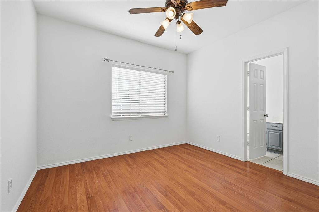 5023 Falcon Hollow Road McKinney, TX 75072 - Photo 19 of 25 Unfurnished bedroom with ceiling fan, light wood-type flooring, and connected bathroom