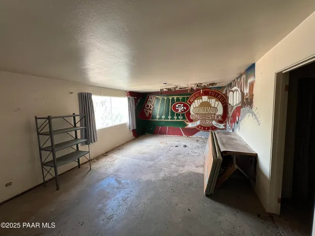 a bedroom with furniture and a flat screen tv
