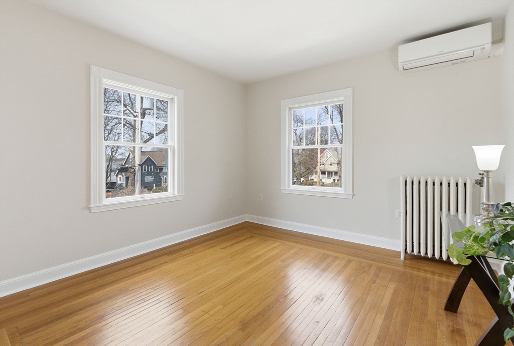 79 Florence Avenue Melrose, MA 02176 - Photo 16 of 35 a view of an empty room with a window and wooden floor