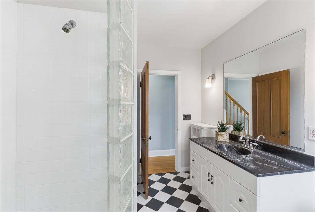 79 Florence Avenue Melrose, MA 02176 - Photo 18 of 35 a bathroom with a granite countertop sink and a mirror