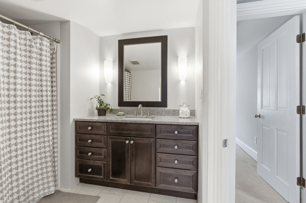 79 Florence Avenue Melrose, MA 02176 - Photo 22 of 35 a bathroom with a granite countertop sink and a mirror