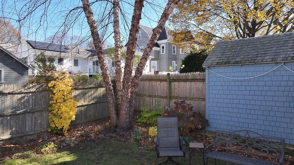 79 Florence Avenue Melrose, MA 02176 - Photo 27 of 35 a view of a house with a yard and wooden fence