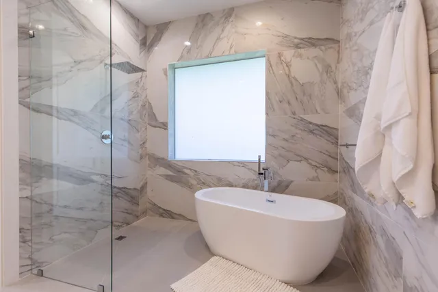 a bathroom with a bathtub and shower