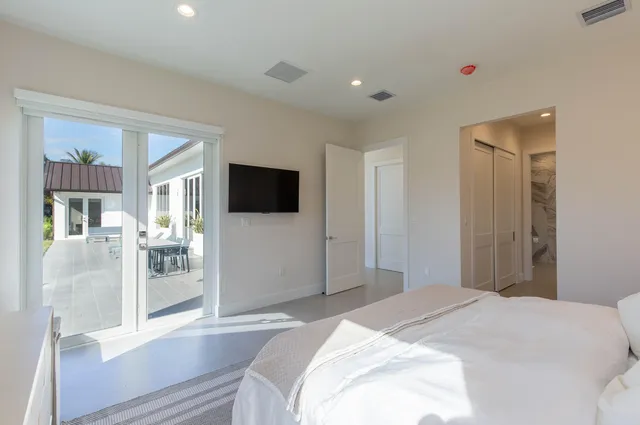 a bedroom with a bed and a flat screen tv